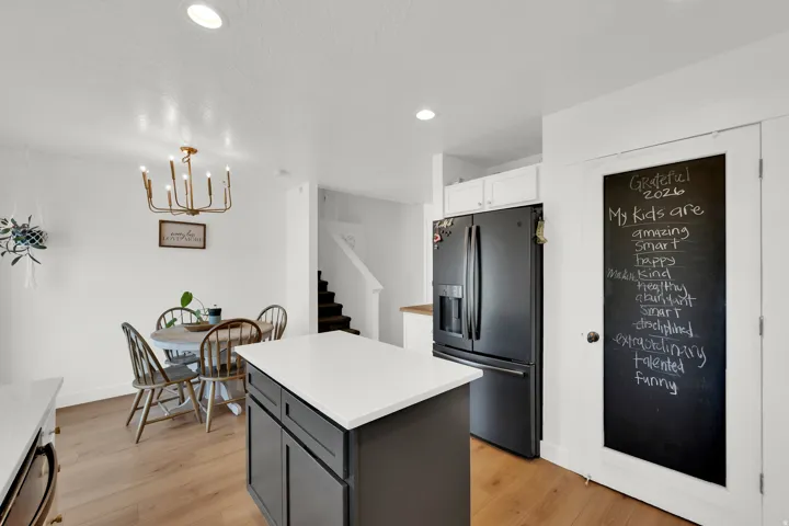 Central kitchen island featuring a light-toned countertop and dark cabinetry