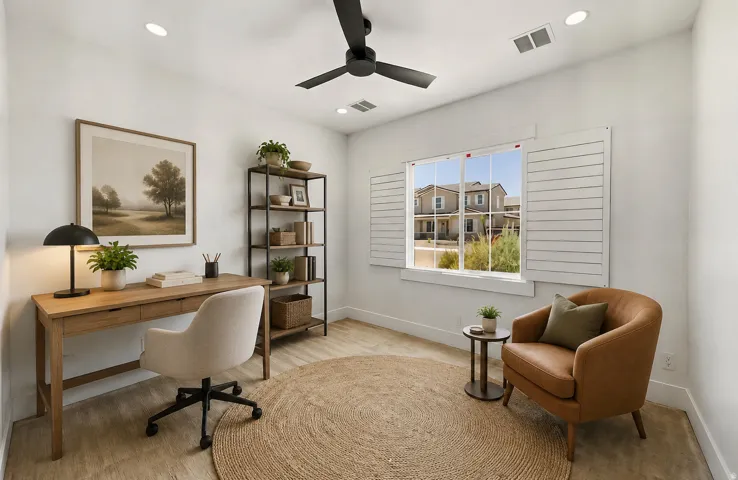 Interior room featuring light wood-finish flooring and a window with white louvered shutters