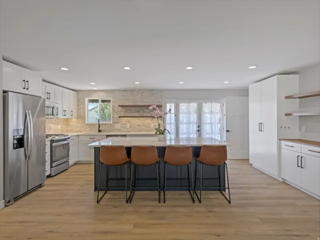 Modern kitchen with a central island featuring a light-toned countertop