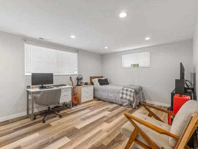 Neutral gray walls with recessed lighting and wood-finish flooring