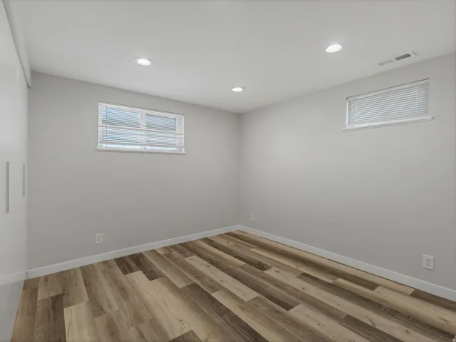 Room featuring wood-finish flooring and neutral wall tones