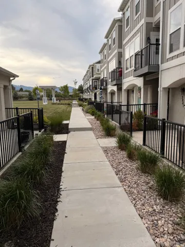 Community pathway bordered by contemporary townhomes