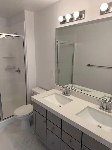 Dual vanity with integrated sinks and chrome fixtures