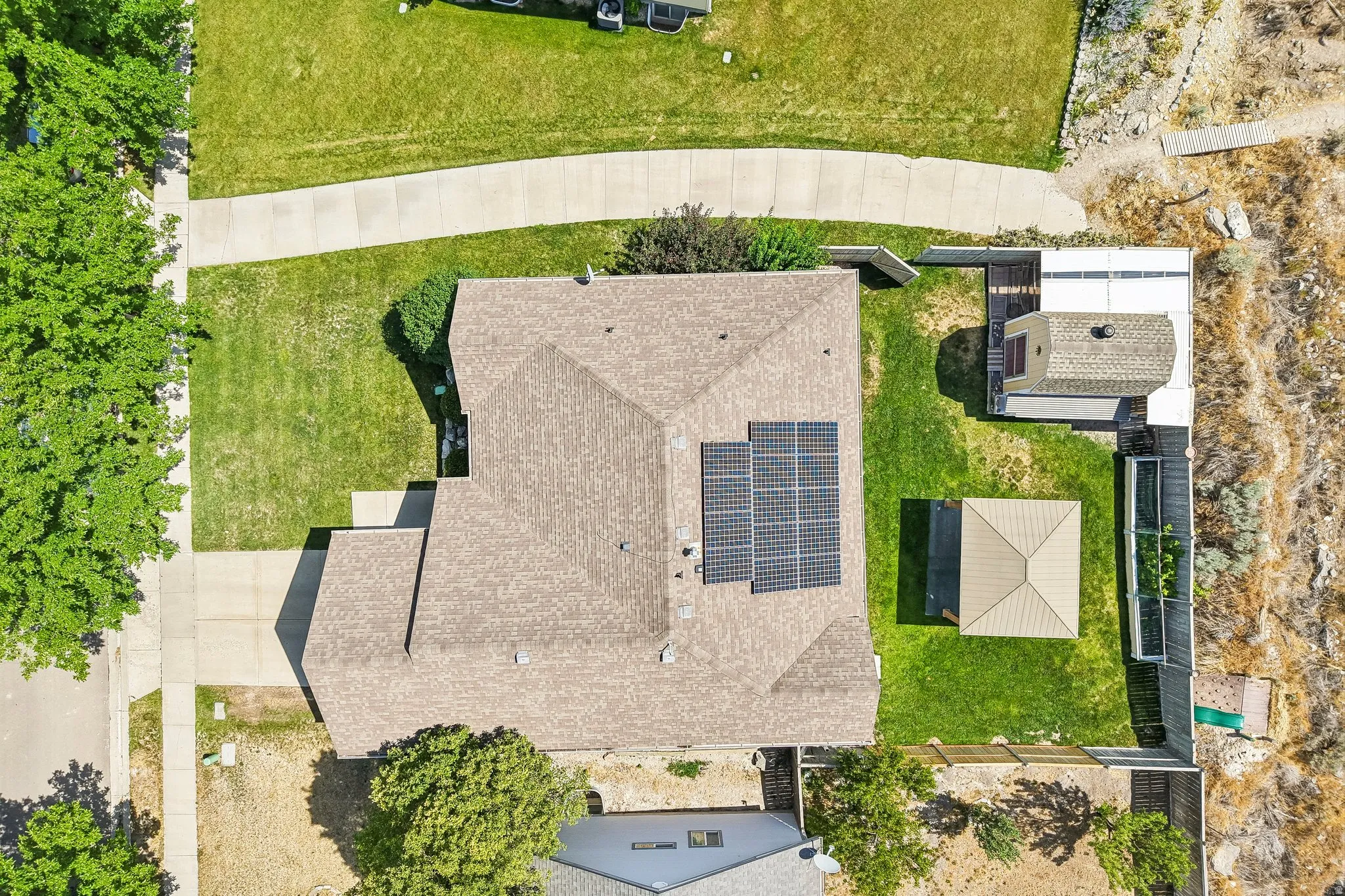 Asphalt shingle roofing with installed solar panels
