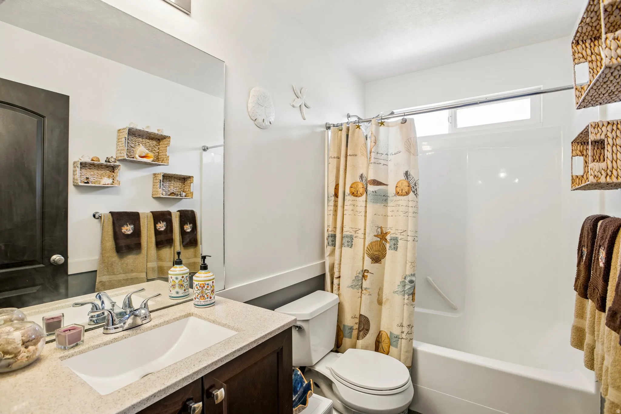 Bathroom featuring a vanity with an integrated sink, polished chrome faucet, and speckled countertop