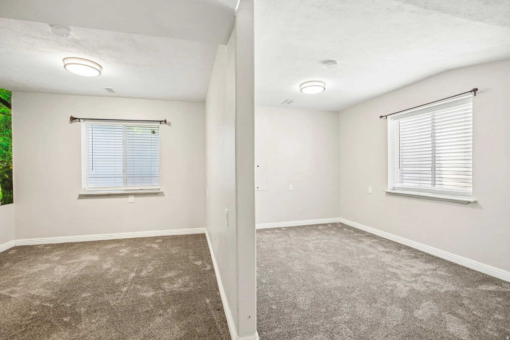 Neutral wall color with white trim and grey carpeting