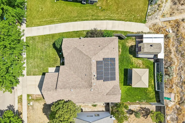 Asphalt shingle roofing with installed solar panels