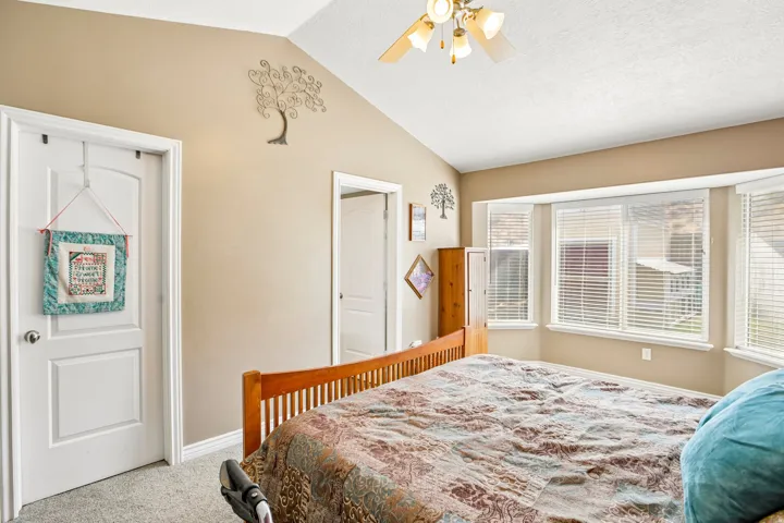 Vaulted ceiling featuring a ceiling fan with integrated lighting