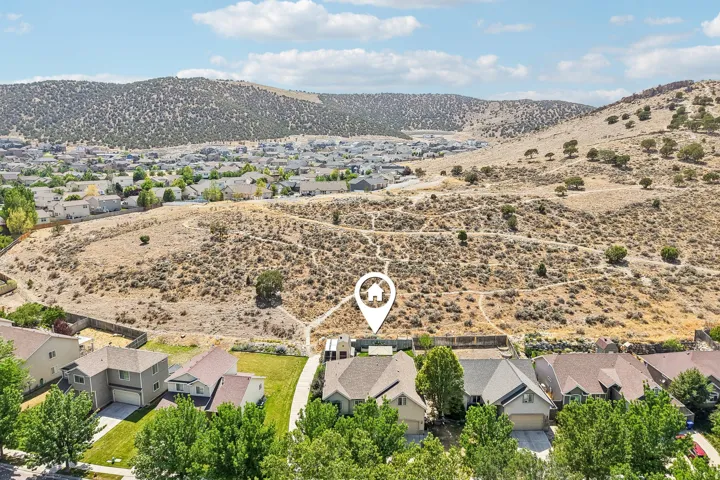 Community setting with a backdrop of arid hills and distant residential development