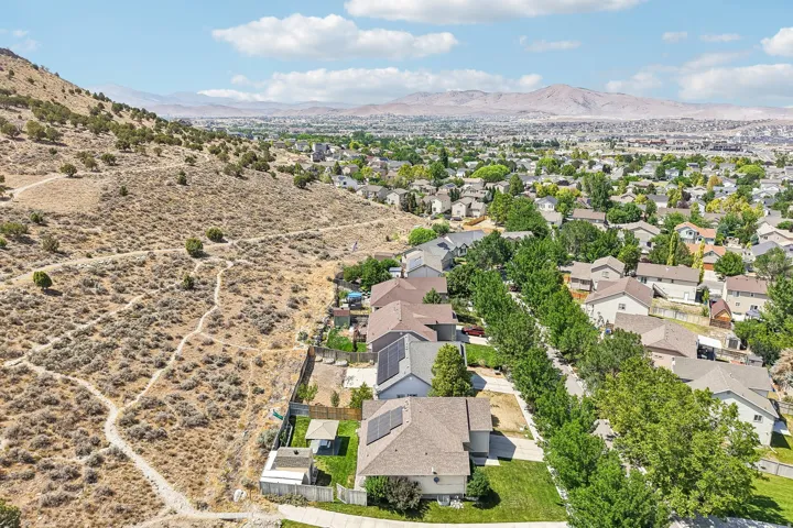 Residential community featuring established homes with pitched roofs, some including solar panel installations