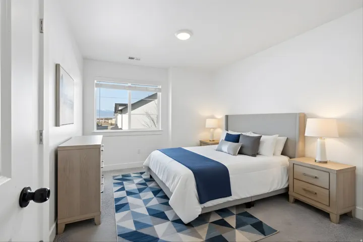 Bedroom featuring a carpeted floor, white walls, and a recessed ceiling light