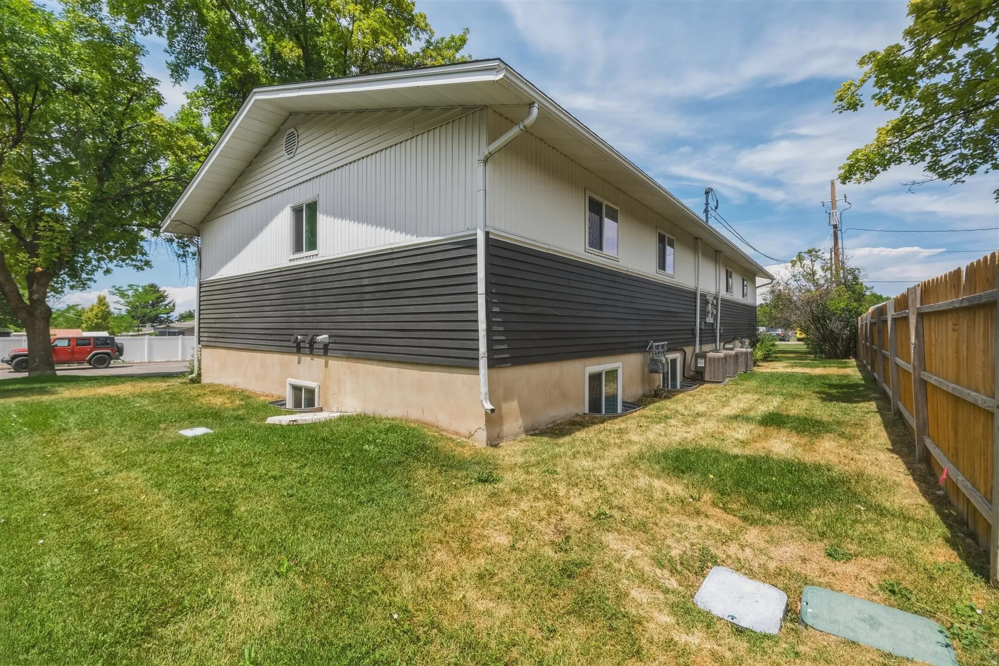 Two-story exterior with a contrasting dark and light horizontal siding design