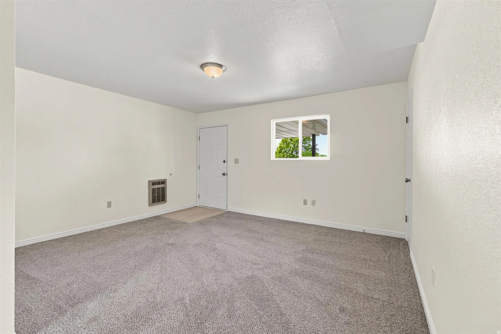 Neutral-toned walls complement the gray carpeting
