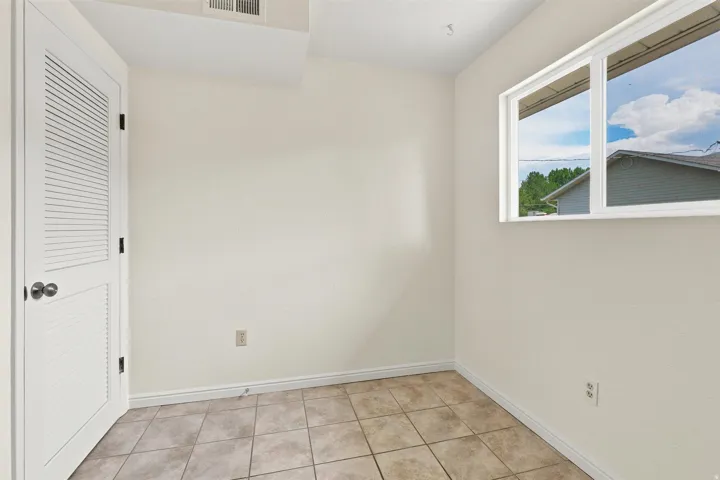 Neutral-toned walls complement the square tile flooring
