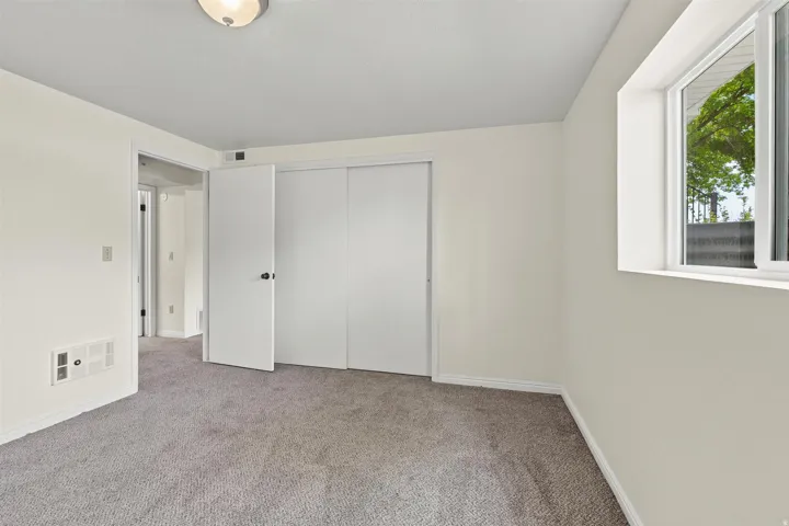 Carpeted interior space featuring white walls and white trim