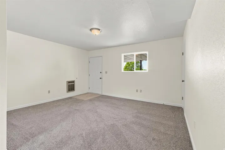 Neutral-toned walls complement the gray carpeting