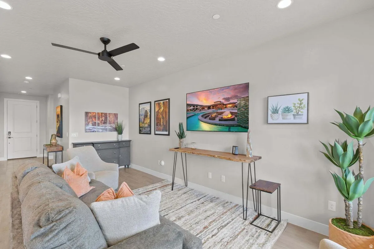 Open-concept living area with light-toned wood-finish flooring