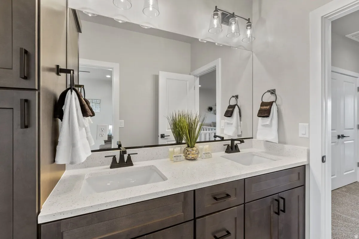 Double vanity with quartz countertop, dual integrated sinks, and matte black hardware