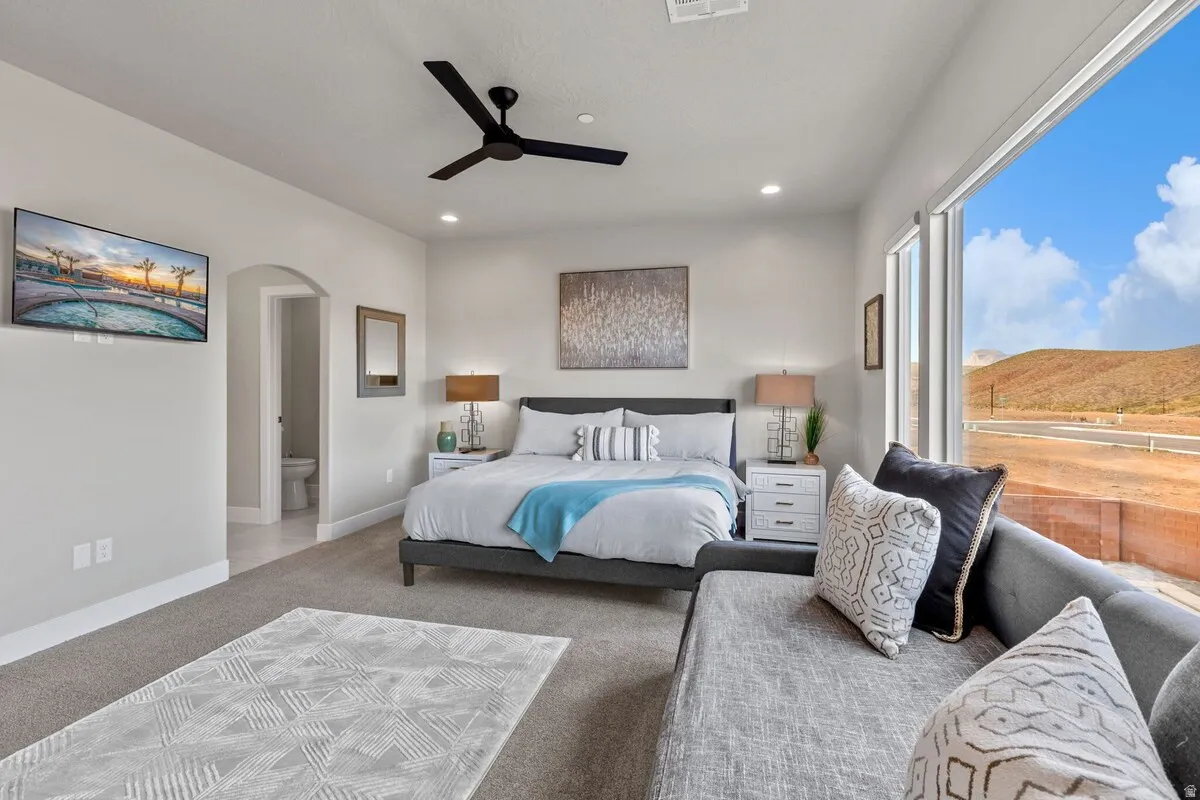 Expansive bedroom featuring large windows, recessed lighting, and a contemporary ceiling fan