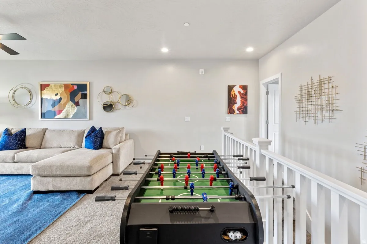 Recreation area featuring a foosball table, light gray wall paint, recessed lighting, and a contemporary ceiling fan