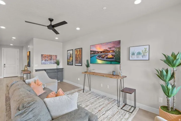Open-concept living area with light-toned wood-finish flooring
