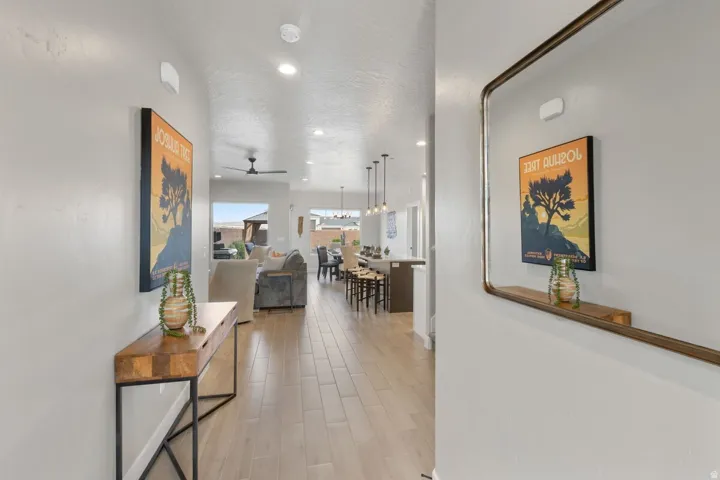 Entryway with wood-finish flooring extending into the open-concept living space