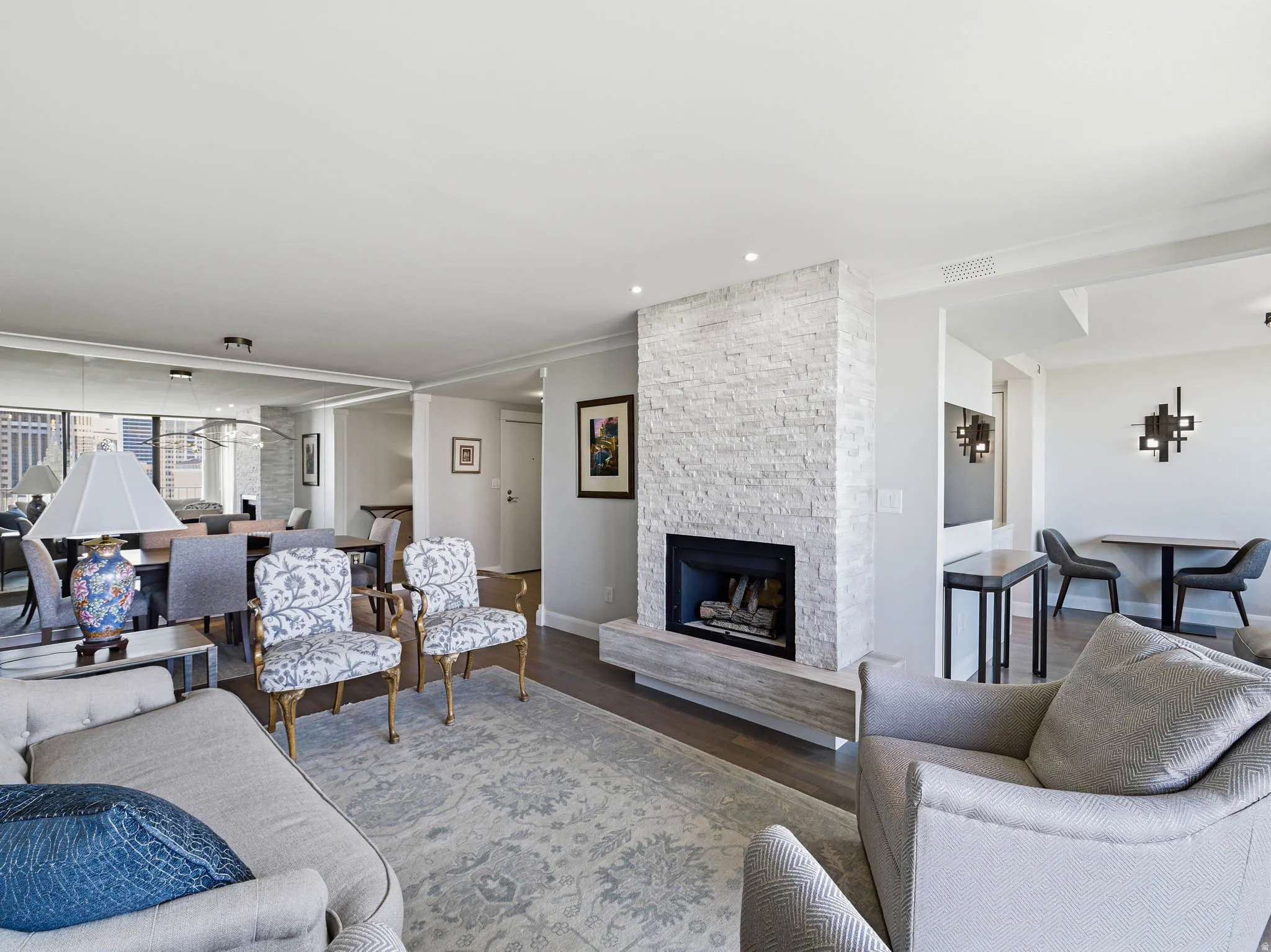 Living area featuring a floor-to-ceiling stone-clad fireplace with a hearth