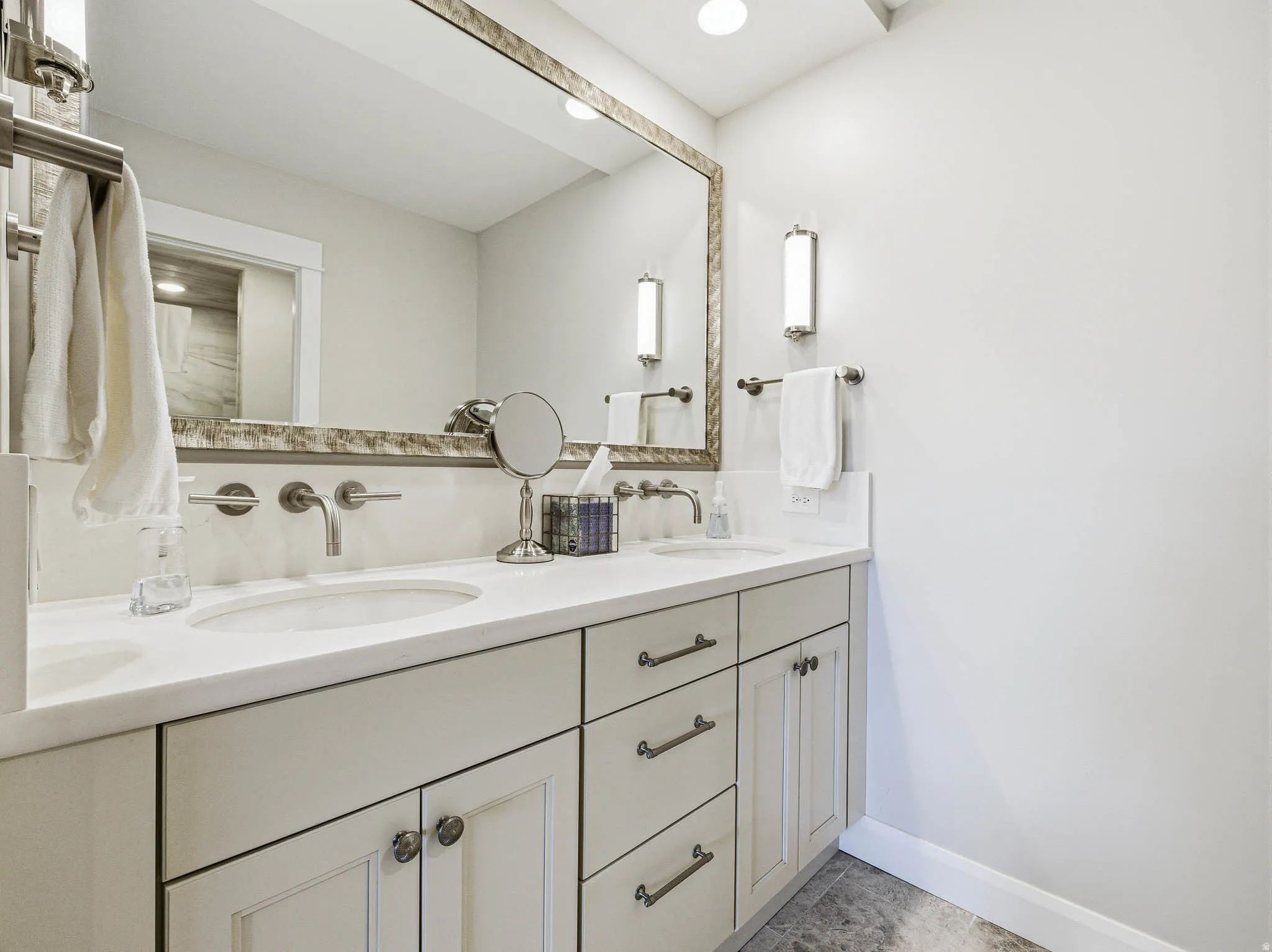 Dual vanity with undermount sinks and wall-mounted faucets