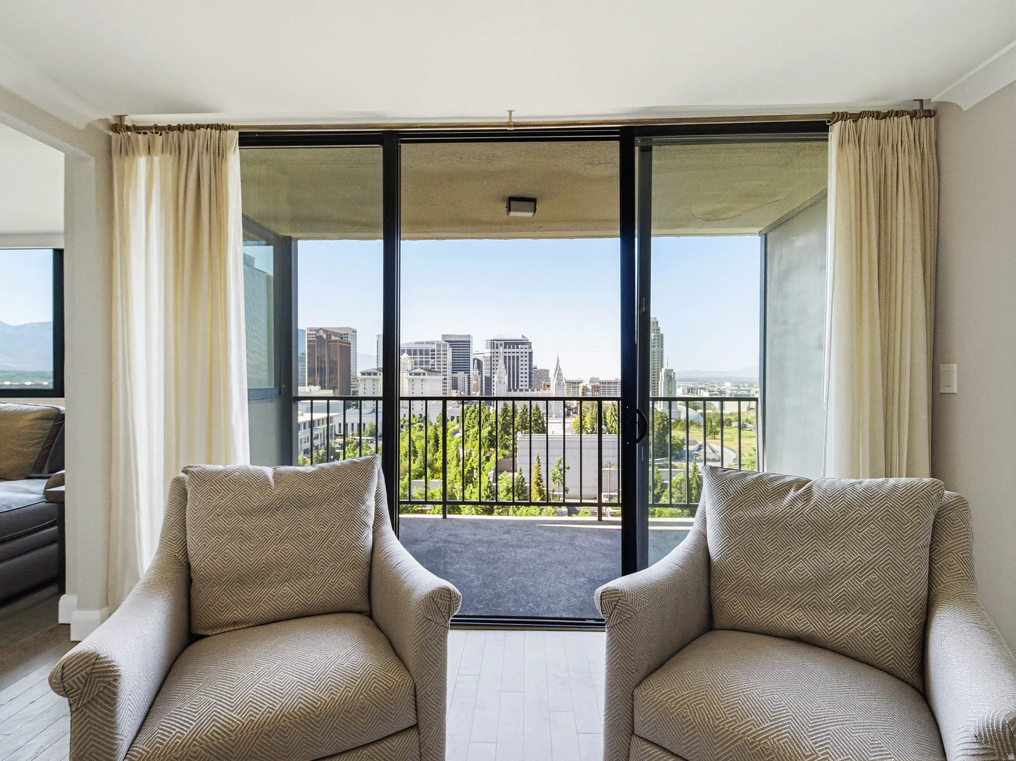 Expansive sliding glass doors provide access to an outdoor balcony