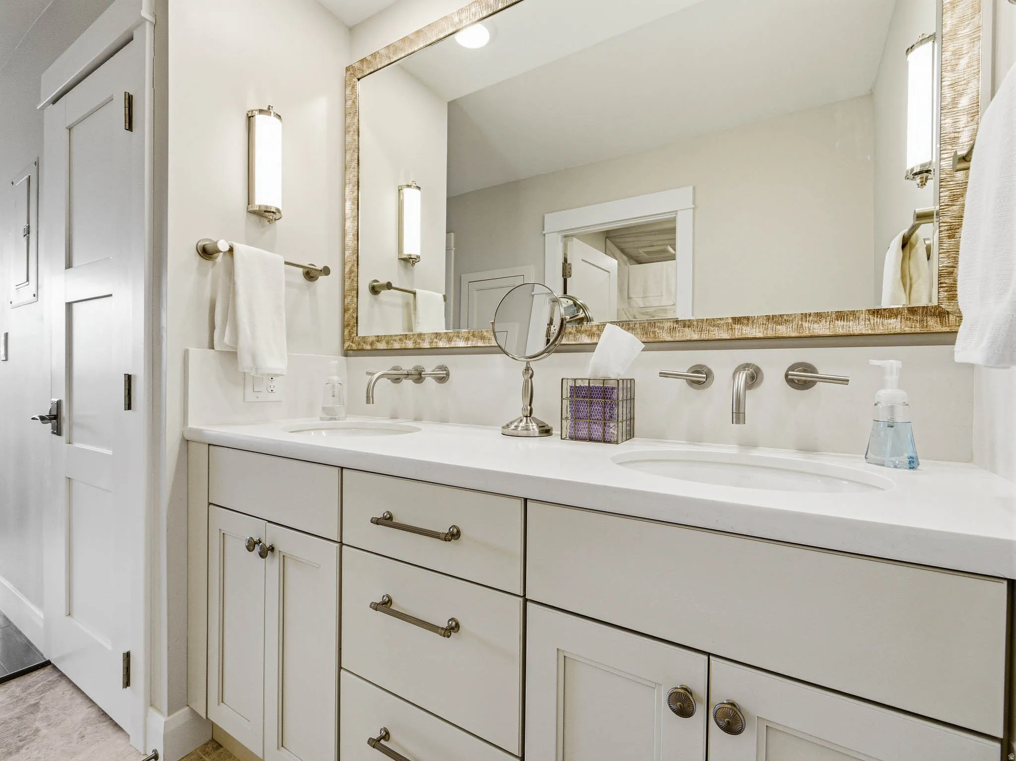 Double vanity featuring wall-mounted faucets and integrated sinks