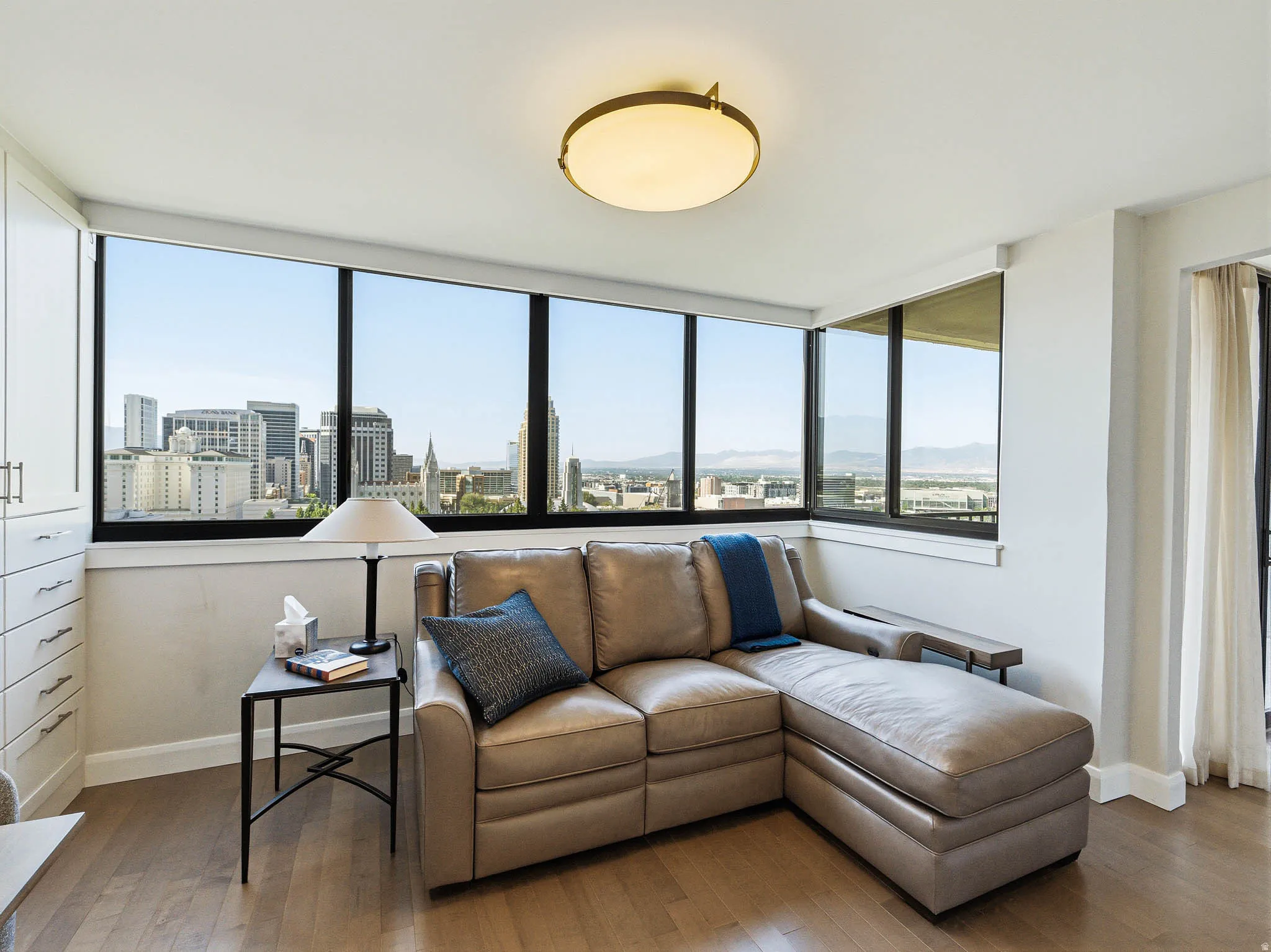 Expansive window wall showcasing city and mountain scenery