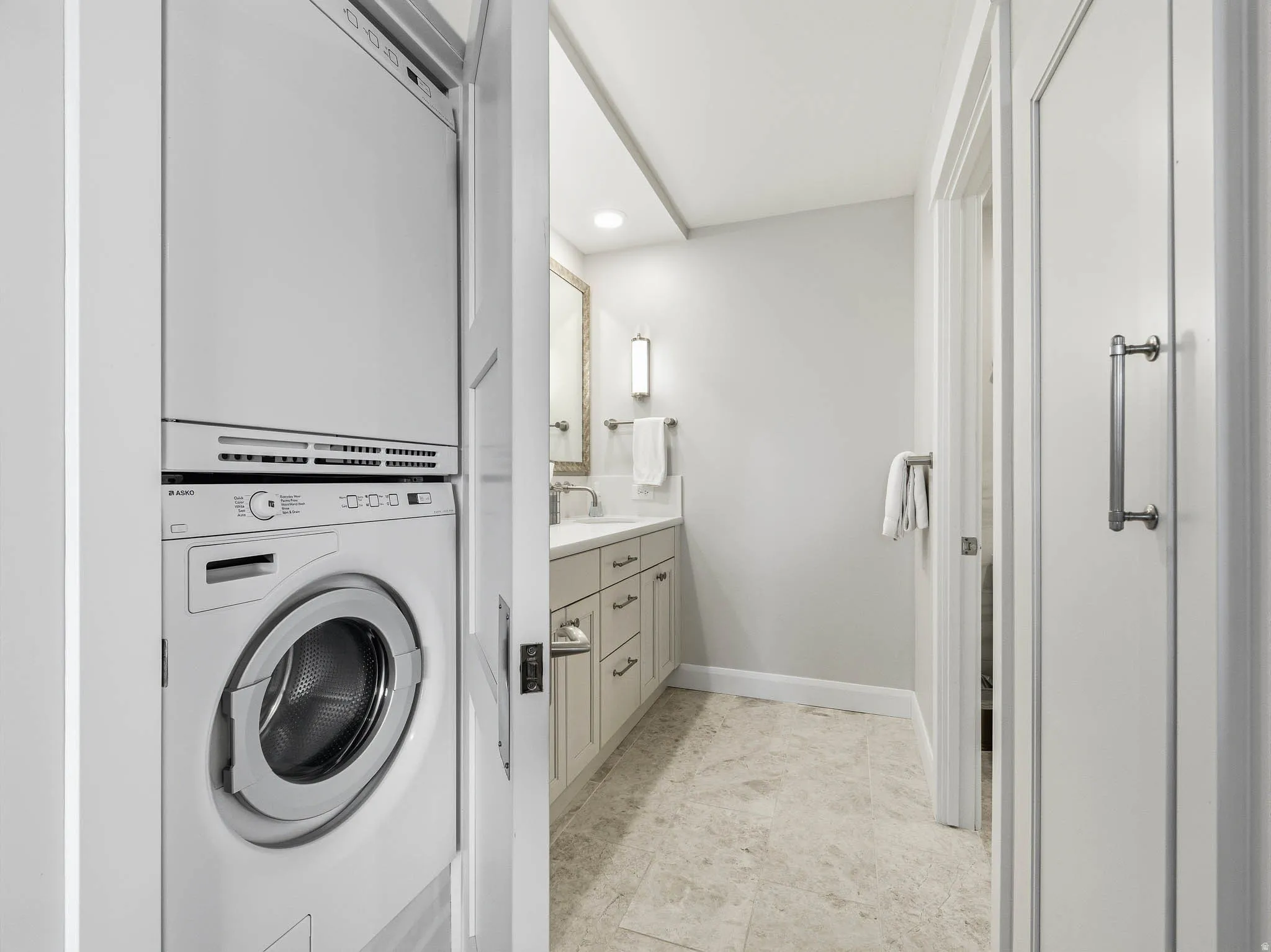 Compact stacked washer and dryer unit, integrated into a hallway alcove
