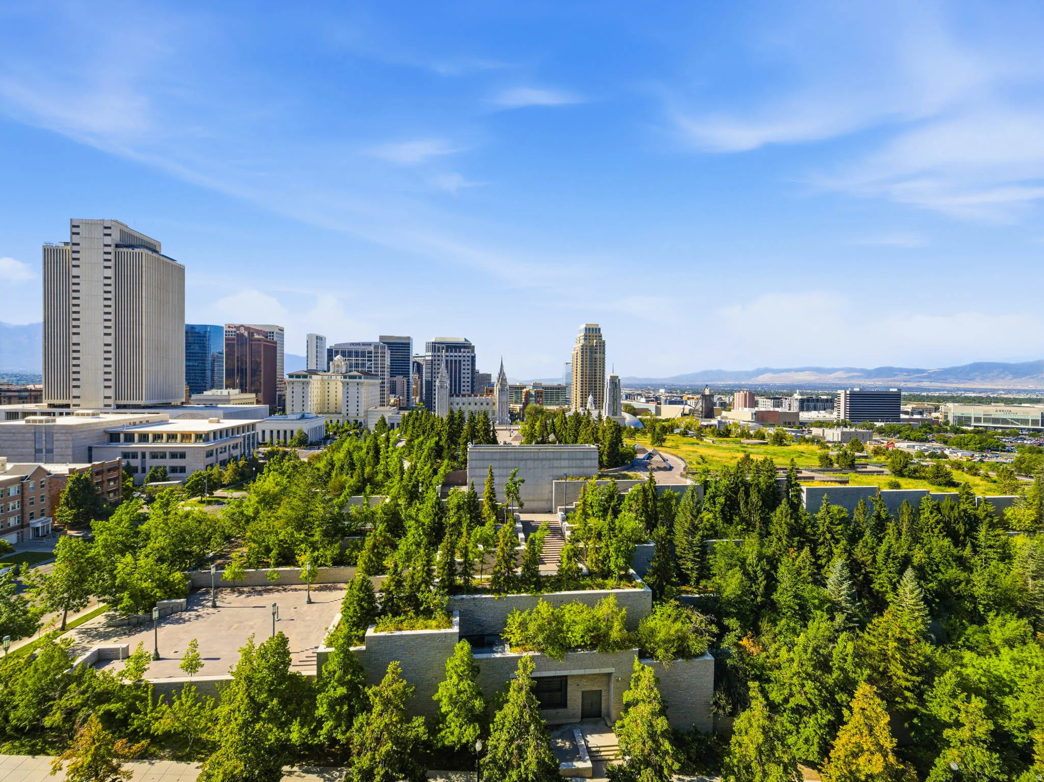Urban skyline featuring multiple high-rise buildings and surrounding green spaces