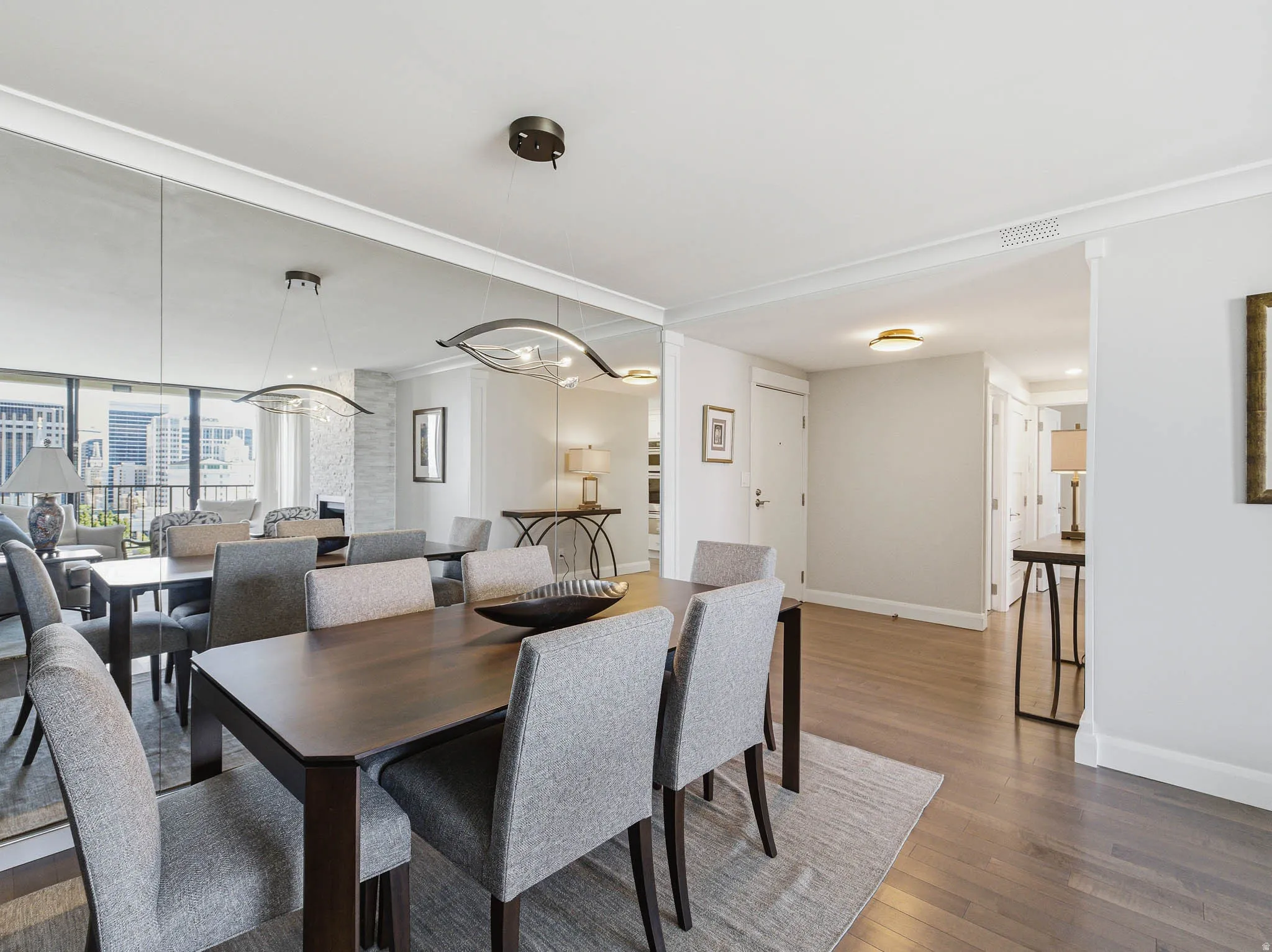 Dining area featuring dark wood-finish flooring and crown molding