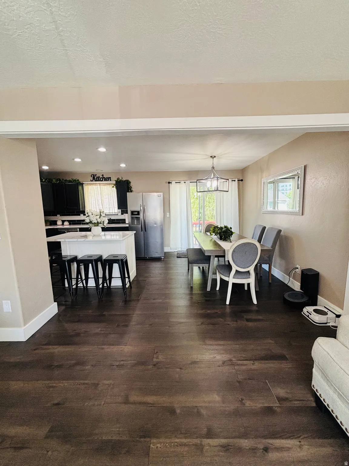 Open concept living space featuring dark wood-finish flooring