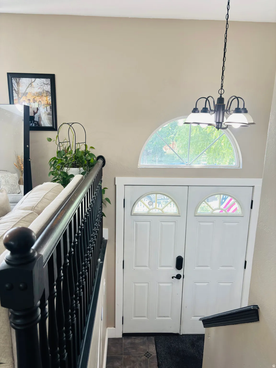 Double entry doors with transom windows, featuring a decorative half-round window above