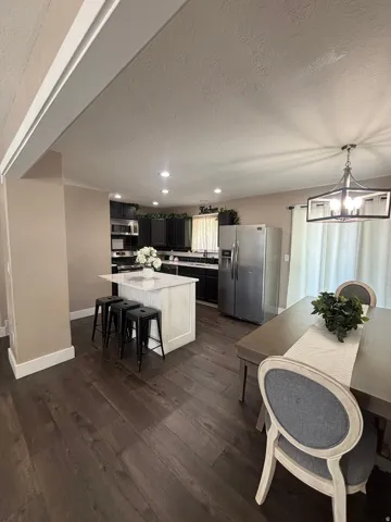 Kitchen featuring dark cabinetry, stainless steel appliances, and recessed lighting