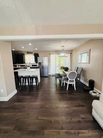 Open concept living space featuring dark wood-finish flooring