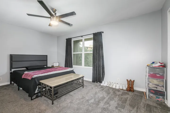 Spacious room featuring light gray walls and gray carpet