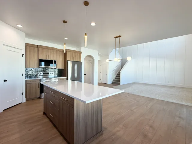 Kitchen island with a white countertop and wood-finish cabinetry