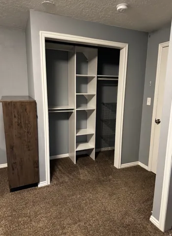 Well-appointed closet system featuring multiple shelves and hanging rods