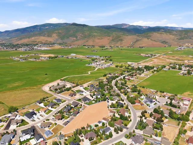 Aerial perspective showcasing a residential development with established homes and vacant lots