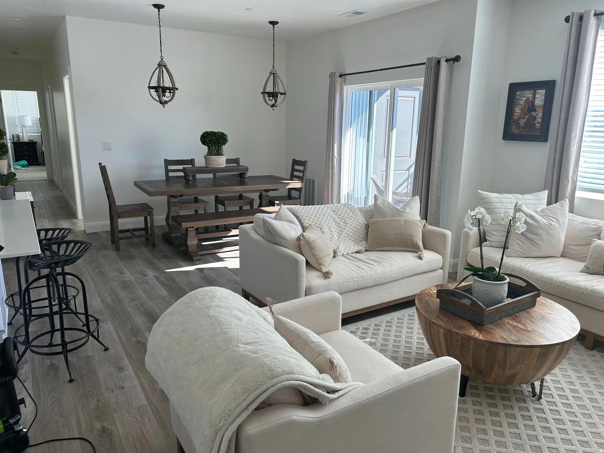 Open-concept living space featuring wood-finish flooring, recessed lighting, and a sliding glass door
