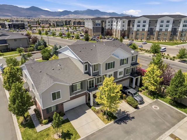 Modern townhome-style residences featuring multi-level construction, attached garages, and private balconies