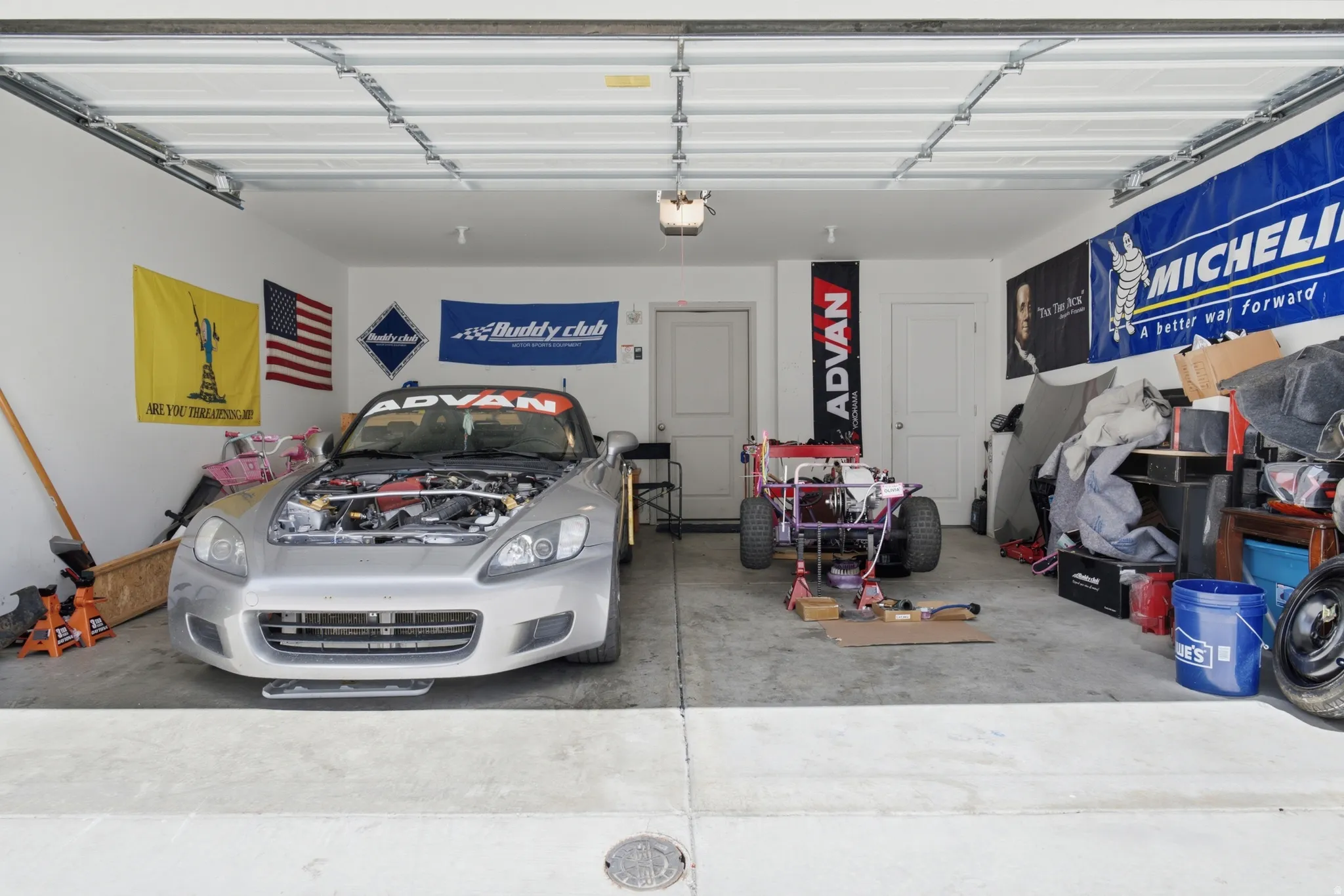 Two-car garage featuring a concrete floor, white walls, and two interior doors