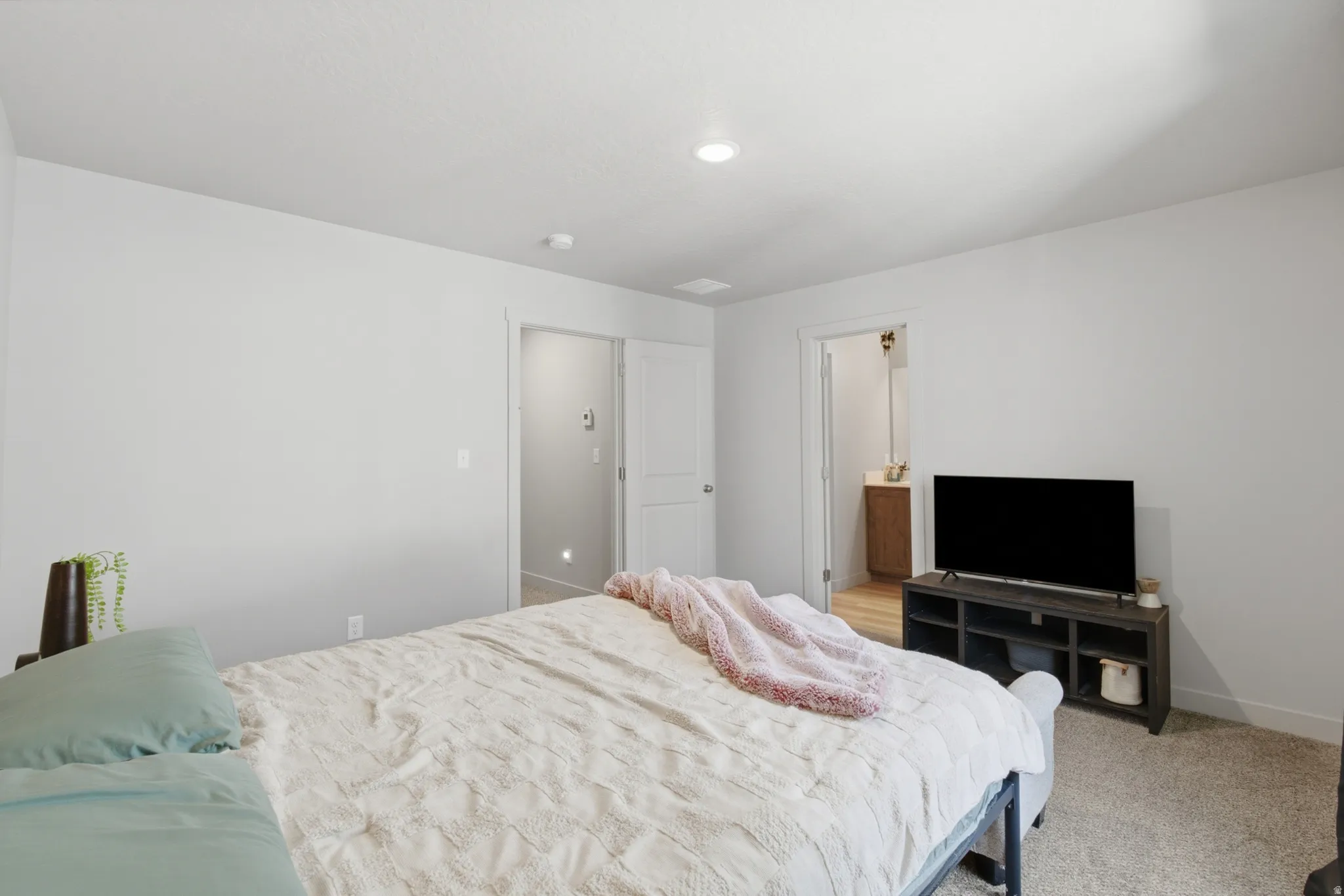Carpeted room with recessed lighting and neutral wall tones