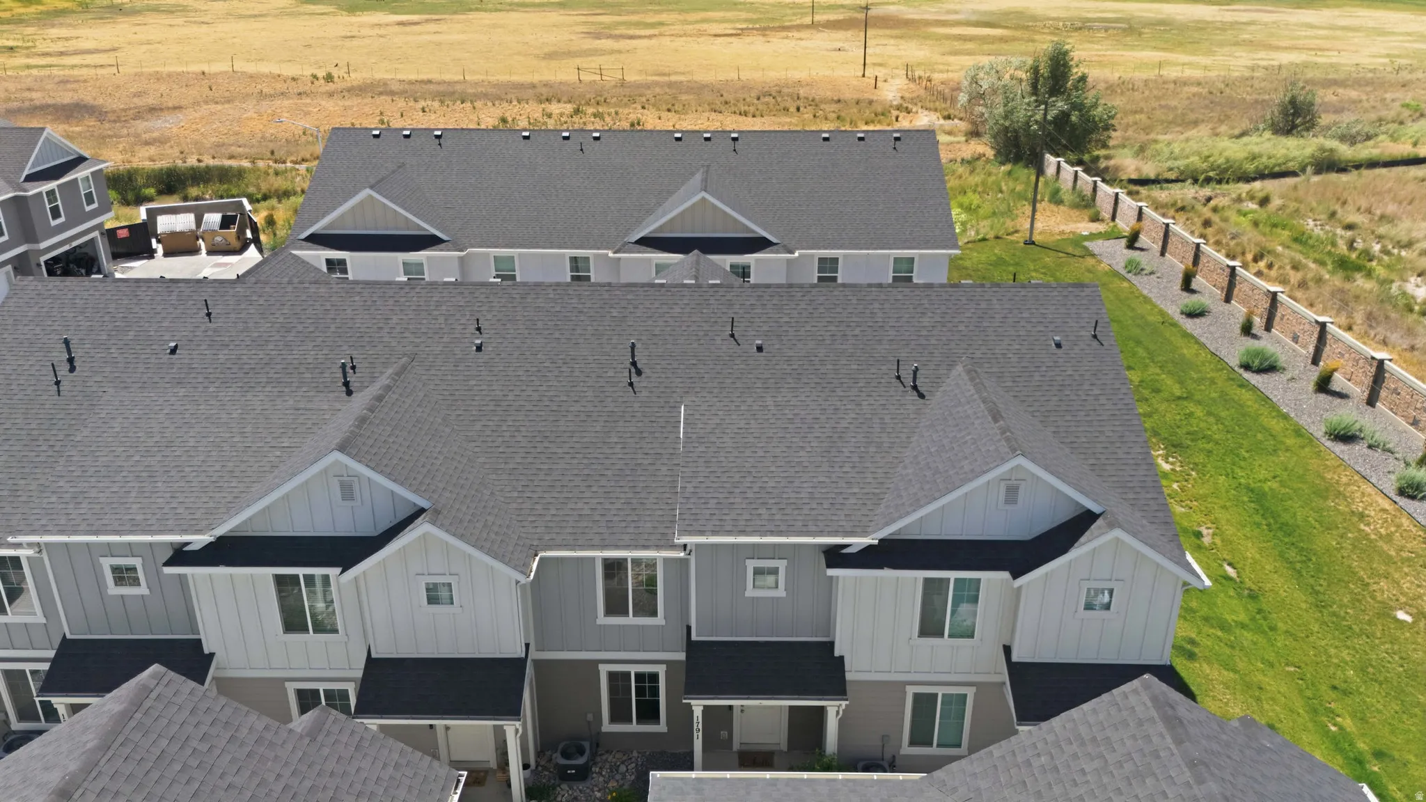 Modern townhome architecture featuring gabled roofs and varied siding textures