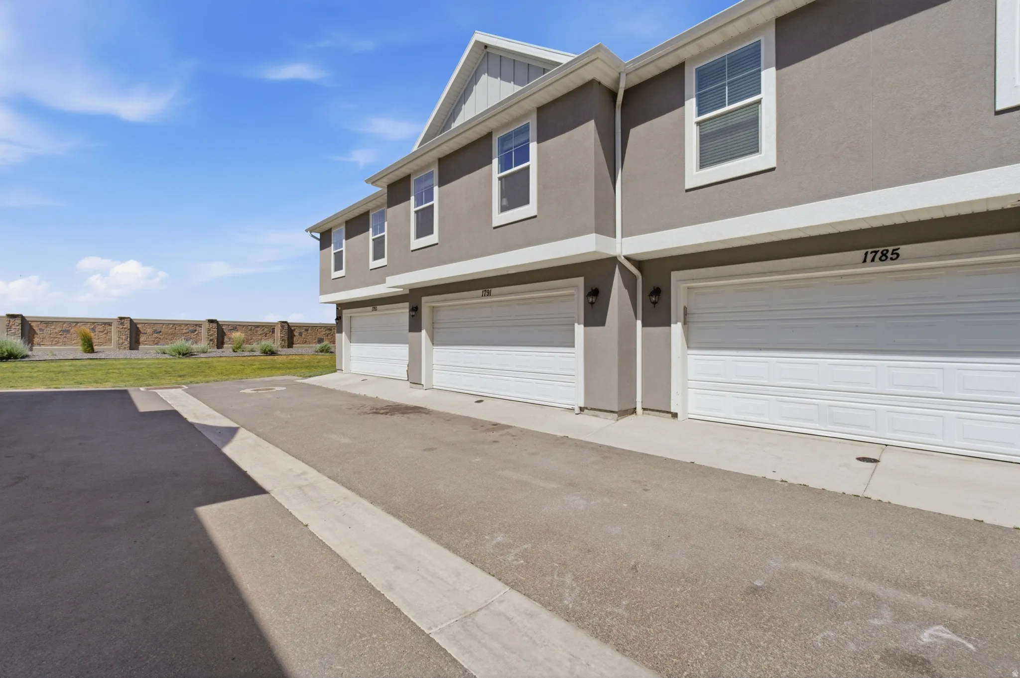 Contemporary multi-story exterior with stucco siding and white trim accents