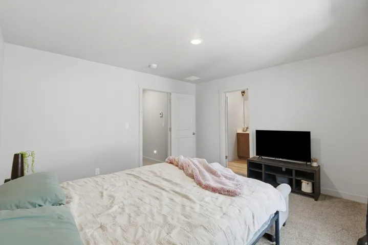 Carpeted room with recessed lighting and neutral wall tones