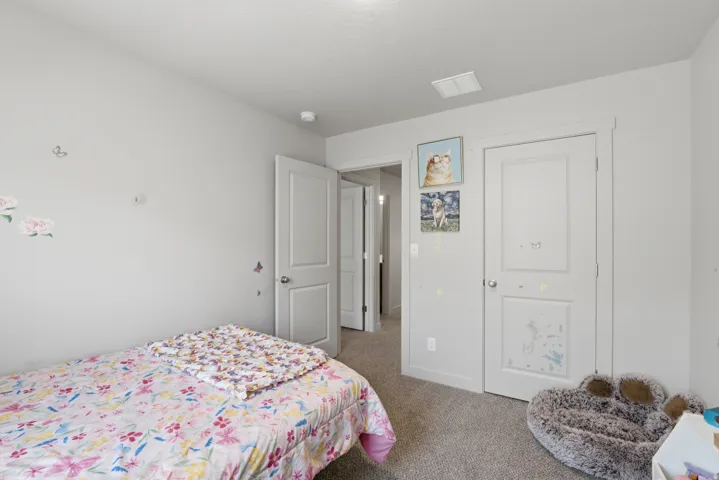 Neutral-toned walls complement the light-colored carpet flooring